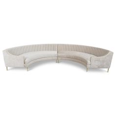 a curved sectional sofa with gold legs