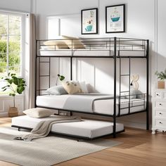 a metal bunk bed with white mattresses in a room next to a wooden floor