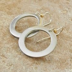 "Sterling Silver Handmade Hoop Earrings - Thick Hoop Earrings - Silver and Gold Hoops - PMC Sterling Earrings These thick hoop earrings were hand formed from 960 sterling silver clay after which they were kiln-fired, tumbled, and hand polished to a gleaming satin finish! Because of the hand construction of the hoops, each has a slightly different shape and character lending them an organic appeal. They hang from sterling silver earwires and are accented with a gold filled bead at the top. These Gift Single Open Circle Hoop Earring, Metal Open Circle Earrings, Everyday Metal Open Circle Earrings, Metal Open Circle Earrings For Everyday, Silver Open Circle Earrings For Pierced Ears, Gift Hoop Earrings With Open Circle, Everyday Metal Circle Earrings, Modern Circular Hoop Earrings For Anniversary, Modern Circle Hoop Earrings For Anniversary