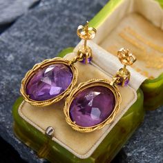 This romantic pair of dangle earrings each feature an oval cut amethyst in a full bezel setting, accented with a twisted rope border. The drop hangs from a round cut amethyst in a four-prong basket setting. The earrings measure 30.0mm long by 16.3mm wide and are finished with posts and friction backs. Antique Engagement Rings Sapphire, Estate Jewelry Rings, Rope Border, Wedding Ring Diamond Band, Basket Setting, Antique Engagement Rings, European Cut Diamonds, Sapphire Engagement, Engagement Rings Sapphire