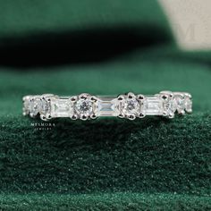 three stone diamond ring on green velvet