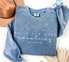 Faith Can Move Mountains Sweatshirt Comfort Colors®, Christian Gift, Faith Shirt, Jesus Hoodie,  Bible Verse Crewneck, Minimal Christian Tee HOW TO ORDER  1 - Check all photos for sizing and color options  2 -Select size and color from the drop-down menus  3 - If the Item is customizable Please add your customization in the Personalization box 4 - Add to cart & Place order  5 - Your shirt is now off to production and will be ready for shipment in 1-2 days! 🎁 PLEASE NOTE This is a standard unisex size Comfort Colors Tee. Women typically wear one size down from their normal women's size or select your normal women's size for a little extra room and to tie it. For an oversized tee, please size up. If you are looking for an oversized "T-shirt Dress" look, we recommend sizing up 2 sizes. Pleas Faith Can Move Mountains Shirt, Inspirational Winter Sweatshirt With Relaxed Fit, Inspirational Relaxed Fit Sweatshirt For Winter, Christ Gifts, Ipad Notes, Faith Moves Mountains, Faith Can Move Mountains, Unique Fits, Oversized Crewneck