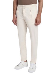 Ivory-coloured cotton trousers with jogger-style waist. The Kiton trouser, an icon of casual style, is reinterpreted with a relaxed twist thanks to volumes that are roomier at the pelvis, wide on the leg and narrower at the bottom in order to offer an authentic experience of comfort. The drawstring waist with a sporty soul meets darts inspired by the world of tailoring to express the casual and elegant vocation of the garment. The opening of the leg is 18 cm on a base size of 50 (Italian). We recommend hand washing inside-out at 30 C. Dry cleanComposition: 97% Cotton, 3% Elastane, Detail, 100% Cotton Classic Cream Tapered Leg Pants, Cream Tapered Leg Cotton Pants, Cream Tapered Leg Cotton Bottoms, Cream Cotton Tapered Leg Pants, Off White Cotton Pants For Work, Cream Tapered Leg Bottoms With Welt Pockets, Cream Cotton Pants With Welt Pockets, Classic Cotton Cream Pants, Classic Cream Cotton Pants