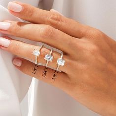 a woman's hand with three different rings on her fingers and one has a diamond ring