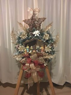 a christmas wreath on top of a wooden stand