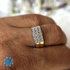 a person's hand with a diamond ring on it