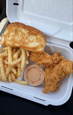 a chicken sandwich and fries in a styrofoam container