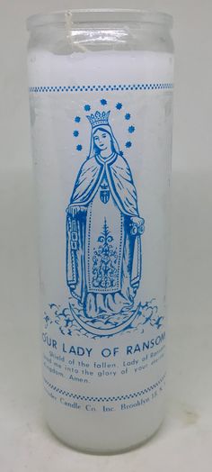 a candle that is sitting on a white surface with a blue and white design in the middle