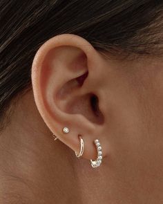 a woman's ear is shown with three different types of piercings