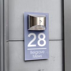 a sign on the side of a building that says 28 belgrave mews