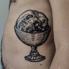 a man with a tattoo on his stomach has a bowl of ice cream in it