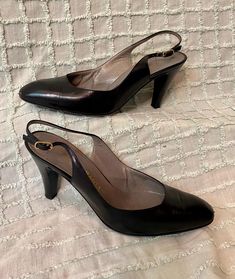 Elevate your style with these vintage black leather pumps by Bruno Magli. These sling back stilettos are perfect for a cocktail party or a night out in the 1980s. The pumps are made with genuine leather, ensuring durability and comfort. The tailored look adds a touch of sophistication to your outfit. These original pumps are a must-have for any fashion enthusiast. They are available in women's size 7 and were made in Italy. Add a touch of elegance to your wardrobe with these timeless pumps. These shoes are in great vintage condition with minor signs of wear, see photos Classic High Heel Slingback Pumps For Party, Classic Slingback Pumps With 4-inch Heel For Party, Classic Slingback Pumps With Almond Toe For Party, Retro Ankle Strap Heels For Formal Occasions, Classic Party Slingback Pumps With Almond Toe, Classic Almond Toe Slingback Pumps For Party, Classic Closed Toe Slingback Pumps For Evening, Classic Slingback Pumps For Party, Classic Black Slingback Pumps For Party