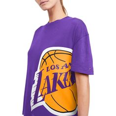 The Tommy Jeans Purple Los Angeles Lakers Bianca T-shirt is a must-have for devoted Los Angeles Lakers fans. With a crew neck and drop shoulders, this comfortable tee boasts screen-printed graphics that proudly showcase your allegiance to the iconic team. Crafted from a cotton and polyester blend, this T-shirt is perfect for game day or any day you want to show your unwavering support for the team. Screen print graphics Drop shoulders Officially licensed Machine wash, tumble dry low Material: 60 Athleisure Crew Neck T-shirt With Logo Print, Sports Fan T-shirt With Logo Print And Crew Neck, Purple Crew Neck T-shirt With Front Print, Sports Purple T-shirt With Logo Print, Purple Sports T-shirt With Logo Print, Collegiate Streetwear Tops With Logo Print, Graphic Print Crew Neck T-shirt For Sports Events, Collegiate Crew Neck T-shirt For Streetwear, Sports Fan T-shirt With Screen Print And Crew Neck