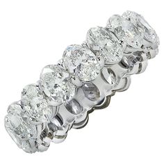 Exquisite Vivid Diamonds eternity band crafted in Platinum, showcasing 17 stunning GIA certified oval diamonds weighing 5.35 carats total, D-E color, VVS-VS clarity. Each diamond was carefully selected, perfectly matched and set in a seamless sea of eternity, creating a spectacular symphony of brilliance and fire. This sensational band measures 5.3 mm in width. It weighs 6.4 grams and is a size 7. This spectacular band was designed to sit low on the finger for maximum comfort. Our pieces are all 7 Carat Diamond Ring, Asher Cut Diamond, Oval Eternity Band, Memory Ring, Diamond Wrap Ring, Engagement Rings Romantic, Modern Wedding Rings, Emerald Cut Diamond Engagement, Pink Diamond Ring