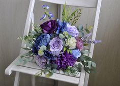 a bouquet of flowers sitting on top of a white chair