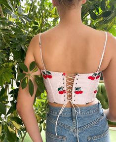 Be a bold cherry bomb in the Cherry Smash Draped Corset. Designed with a bustier silhouette and a supportive corsetry boning, the adjustable corset highlights your waist and elongates your neckline. The pretty half cups are softly lined with underwire for full support and the ultimate uplift. You’ll be the ultimate Cherry Smash of summer. Fitted Lace-up Back Crop Top For Spring, Fitted Crop Top With Lace-up Back For Spring, Fitted Corset With Boned Bodice And Spaghetti Straps, Summer Sweetheart Neckline Corset With Boning, Spring Fitted Boned Bodice Corset, Summer Corset Back Underbust Crop Top, Summer Underbust Crop Top With Corset Back, Summer Sleeveless Lace-up Corset, Summer Sleeveless Corset With Lace-up Back