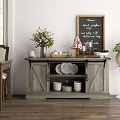 a table with plates and cups on it in front of a chalkboard that says happy birthday