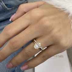 a woman's hand with a diamond ring on it