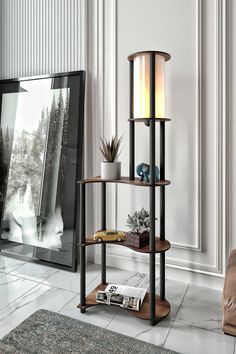 a living room with a lamp and some books on the shelf in front of it