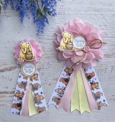 two pink and yellow ribbons with winnie the pooh on them