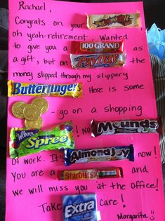 some candy bars are sitting on a pink piece of paper with words written in it