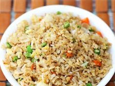 a white bowl filled with rice and vegetables