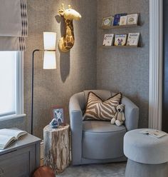 a baby's room with a giraffe head on the wall