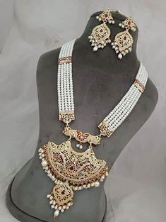 "Incredible timeless ensemble rendered into sophistication to compliment any occasion! Check our Gold Plated Hyderabadi Navratan / Multicolor Jadao Jadau Traditional Necklace set encrusted with multicolor /Navratan colored lab created semi precious  stones with layers of Hyderabadi pearls. Necklace is finished with pearl drops & cluster pearls. Matching earrings makes this set a masterpiece in itself. 👉🏻Approximate necklace length is 30-32\" long adjusted via drawstring. 👉🏻Matching statement Small Pearl Necklace, Jadau Jewellery, Long Pearl Necklace, Necklace Traditional, Rani Haar, White Beaded Necklaces, Traditional Indian Jewellery, Pearl Beaded Necklace, Long Pearl Necklaces