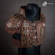 a mannequin's torso with an old leather armor on it