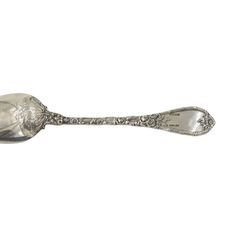 a silver spoon sitting on top of a white surface