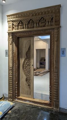 an ornate carved wooden door in a room