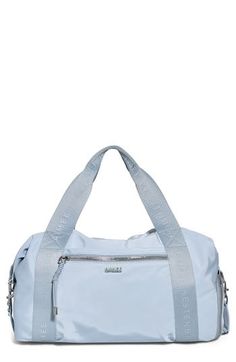 This lightweight duffle with webbed top handles and an optional shoulder strap is the perfect carryall for travel or the gym. A trio of exterior zip pockets keeps essentials organized, while a wide strap ensures it slips over your luggage with ease. Two-way top zip closure Top carry handles; adjustable removable shoulder strap Exterior zip pockets; slip pocket with magnetic snap closure Interior zip and slip pockets Slip-through luggage strap Water-resistant Lined Recycled polyester/polyester Im Sporty Large Capacity Tote Luggage, Blue Duffle Bag With Zipper Closure For On-the-go, Sporty Double Handle Gym Bag For On-the-go, Blue Tote Weekender Bag With Zipper Closure, Sporty Zipper Closure Luggage For On-the-go, Sporty Luggage With Zipper Closure For On-the-go, Blue Weekender Bag With Zipper For Travel, Blue Weekender Bag With Double Handle For Travel, Blue Double Handle Weekender Bag