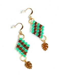 Bring the beauty of the tropics into your life with our Teal and Gold Monstera Charm Beaded Earrings. Handmade with love and attention to detail, these earrings are a statement piece that reflects your unique style and appreciation for the natural world. Order yours today and let these earrings add a touch of tropical elegance to your every day. ► Inspired by Nature: These stunning earrings capture the essence of a lush garden with their vibrant teal and gold color palette. The Monstera house pl Tropical Green Jewelry For Summer, Tropical Green Summer Jewelry, Summer Tropical Green Jewelry, Green Tropical Style Summer Jewelry, Green Dangle Jewelry For Vacation, Handmade Tropical Green Jewelry, Elegant Green Beaded Earrings For Beach, Gold Color Palette, Gold Color Palettes