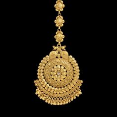 an ornate gold necklace on a black background