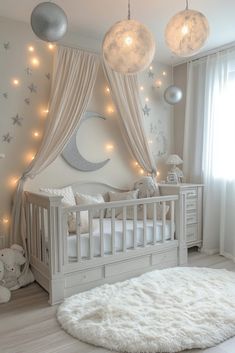 a baby's room with white furniture and lights on the ceiling, including a crib