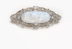 Antique Platinum Carved Moonstone Brooch - DSF Antique Jewelry Elegant Wedding Brooch With Cabochon Detail, White Oval Brooch For Formal Occasions, Luxury Silver Oval Brooches, Victorian White Cabochon Brooches, White Victorian Cabochon Brooches, White Oval Brooch For Anniversary, Art Deco Oval Wedding Brooches, Oval Gemstone Brooches For Weddings, Heirloom Silver Brooch With Rose Cut Diamonds