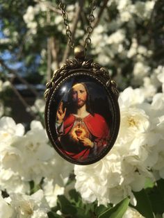 Beautiful pendant of Jesus Christ. The pendant is approx. 2,2 x1,6 inch (5,5 x 4 cm) and is set in a leadfree antique brass setting. The necklace is a very fine leadfree antique brass metal chain (length approx. 42cm). Due to the shape of the glass cabochon the light is reflected, so the real pendant is much more beautiful than the picture. The pendant is delivered in a nice gift pouch. Please feel free to follow me on Pinterest and instagram! Valentine's Day Medallion Jewelry Gift, Spiritual Medallion Necklace For Valentine's Day, Medallion Necklace For Valentine's Day Gift, Handmade Medallion Jewelry For Valentine's Day, Medallion Necklaces For Valentine's Day Gift, Valentine's Day Medallion Necklace Gift, Collectible Spiritual Heart-shaped Necklace, Collectible Spiritual Heart Necklace, Handmade Medallion Necklace For Mother's Day