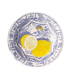 a blue and white plate with lemons on it