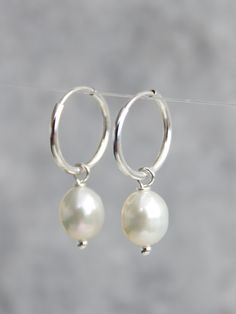 AAA quality 6.5 x 7.5mm white freshwater pearls with very good lustre on a 925 sterling silver 12mm earring hoop. The earrings is approximately 2.4cm long The pearls are genuine freshwater pearls therefore each pearl is slightly different in shape and size and has their own unique blemishes.  Comes with a free gift box All measurement  mentioned in this listing is approximate The colour of the actual earrings might be slightly different to the photo due to the lighting More freshwater pearls ear Silver Teardrop Hoop Earrings With Pearl Charm, Silver Teardrop Pearl Hoop Earrings, Handmade Silver Hoop Pearl Earrings, Small Silver Hoop Earrings With Pearl Charm, Silver Small Hoop Earrings With Pearl Charm, Silver Dainty Hoop Earrings With Pearl Drop, Silver Hoop Earrings With Pearl Drop, Silver Hoop Jewelry With Pearl Drop, Minimalist Silver Hoop Earrings With Pearl Drop