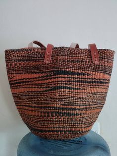 "Black and orange sisal tote bag DIMENSIONS Bottom width: 10\"/25.5cm Top width: 14\"/35.56cm Depth: 10\"/25.5cm Straps: 15\"/38cm SHIPPING All orders ship via DHL Express (3-5) days delivery time." Traditional Black Bag For Everyday Use, Black Woven Bucket Bag With Double Handle, Black Woven Handheld Shoulder Bag, Traditional Black Handheld Bag, Traditional Straw Bag With Adjustable Strap For Everyday, Everyday Large-capacity Basket Bucket Bag, Everyday Large Capacity Bucket Bag In Basket Shape, Everyday Bucket Bag With Large Capacity, Orange Bucket Bag With Large Capacity For Everyday Use