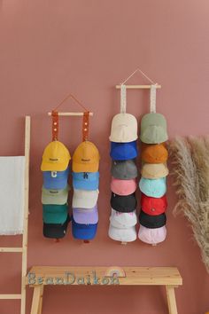 several hats are hanging up on the wall