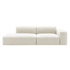 a white couch sitting on top of a white floor