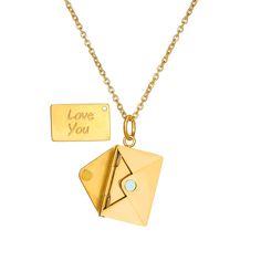 an origami envelope and love you charm on a gold chain