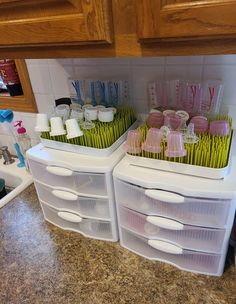 plastic containers filled with toothbrushes on top of a counter