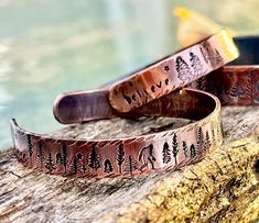 He's elusive a bit like Waldo and bar none one of my most popular cuffs this year. Every hand-stamped Copper Cuff is different as he's always amongst the trees, but where? Cuffs are 6 inches long by 3/8 inches wide in 16 gauge copper. I have added TWO other widths and lengths for larger wrists in separate listings as materials vary according to dimension- With any copper jewelry there will be tarnishing of the patina. Best way to care for my copper is to keep it in a plastic bag and polish it wi Bohemian Hand Stamped Bracelets For Gifts, Bohemian Hand Stamped Bracelets As Gift, Bohemian Hand Stamped Bracelets For Gift, Bohemian Hand-stamped Bracelets For Gifts, Handmade Nature-inspired Cuff Bracelet As Gift, Handmade Nature-inspired Cuff Bracelet Gift, Handmade Nature-inspired Cuff Bracelet, Rustic Stamped Cuff Bracelet Gift, Rustic Bangle Cuff Bracelet As Gift