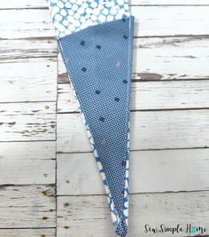 a blue and white polka dot triangle on a wooden background with the words sew simple life written below it