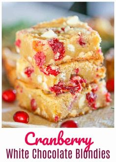 cranberry white chocolate blondies stacked on top of each other with the title