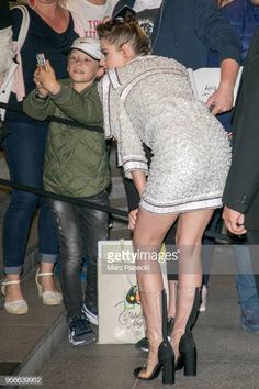 a woman in high heels and a little boy standing next to each other