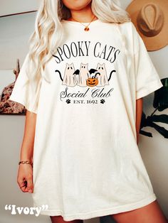 Be on trend this Halloween with this cute and unique Spooky Ghost Cats Social Club Shirt! This Halloween Comfort Colors® Tshirt is sure to be a hit at the Halloween Party or to surprise the Trick or Treaters! Super comfy! Size up for a Trendy Oversized Look! SHIPS FREE! SIZING TIPS: Size up 2-3 sizes from your "usual size" to get the "Oversized" Look! (2 sizes up is most common, and 3 sizes up is more dramatic) For a "relaxed fit" order your "usual size". When in doubt, lay your favorite fitting White Cat Print T-shirt For Halloween, Spooky Cat Print Crew Neck T-shirt, White T-shirt With Cat Print For Fall, Spooky Cotton T-shirt With Cat Print, Casual Halloween Cat Design T-shirt, Halloween White T-shirt With Cat Print, Halloween Graphic Tee With Cat Design, Halloween Cat Print Graphic Tee, Halloween Cat Design Graphic Tee