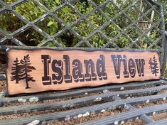 a wooden sign sitting on top of a metal bench